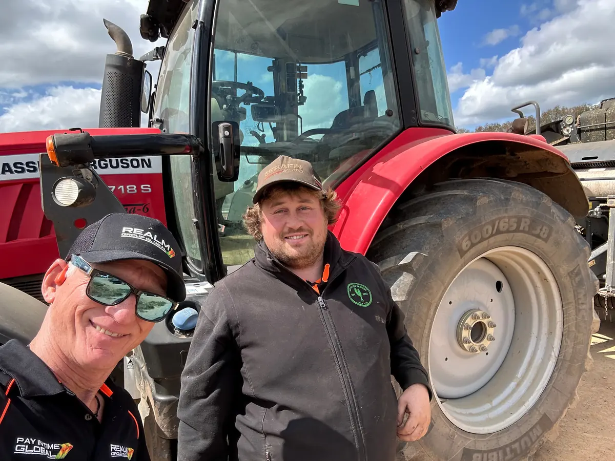 REALM team members in front of a tractor
